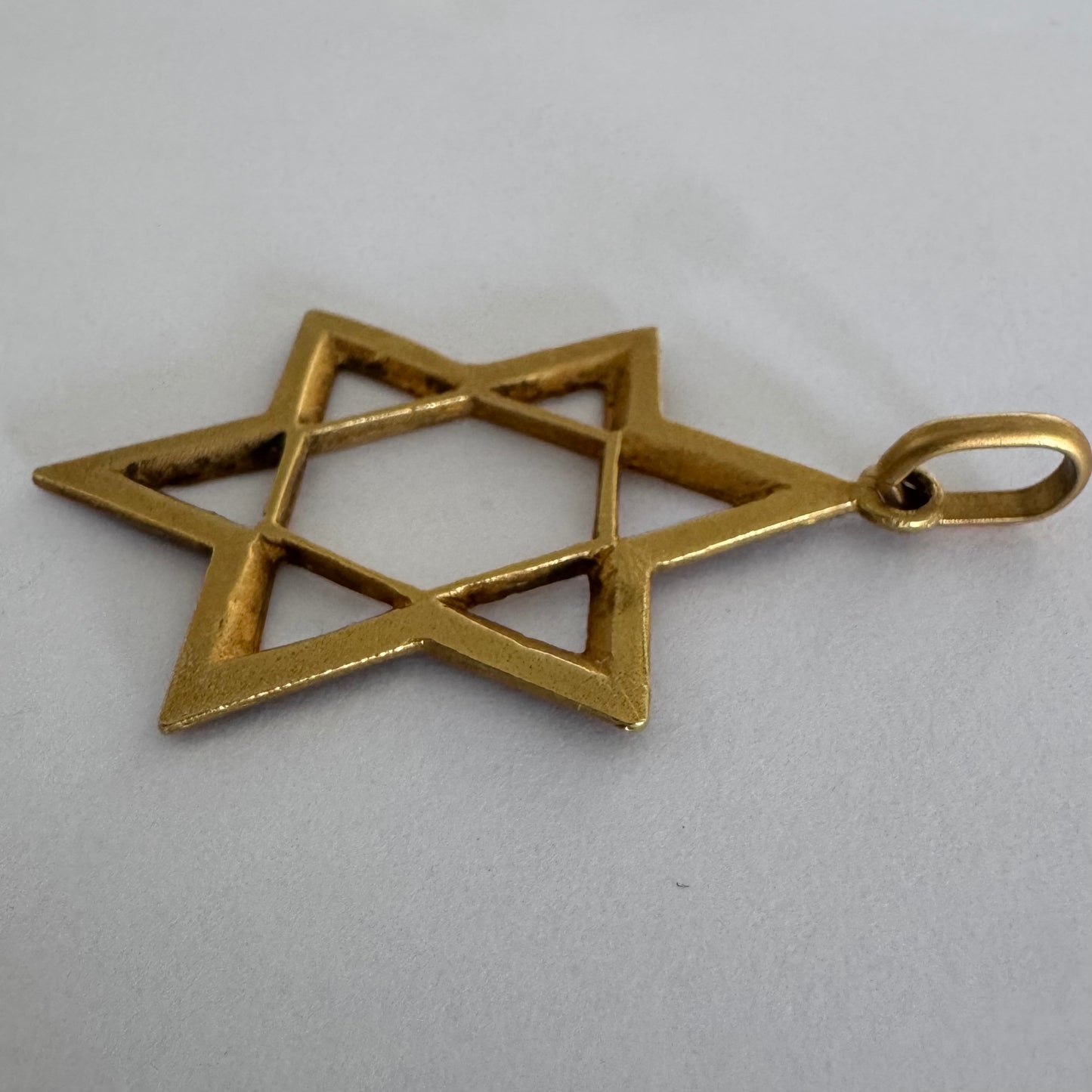 14K gold Star of David pendant with textured detailing and an open design.