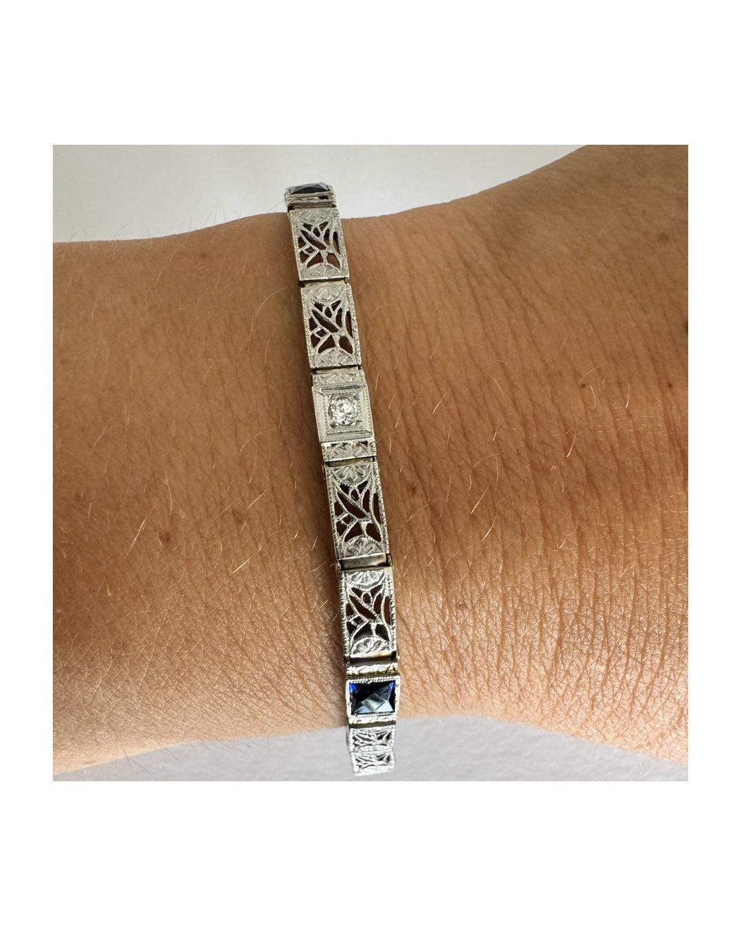 14K gold bracelet featuring intricate openwork and beautifully engraved details set with Sapphire & Diamonds