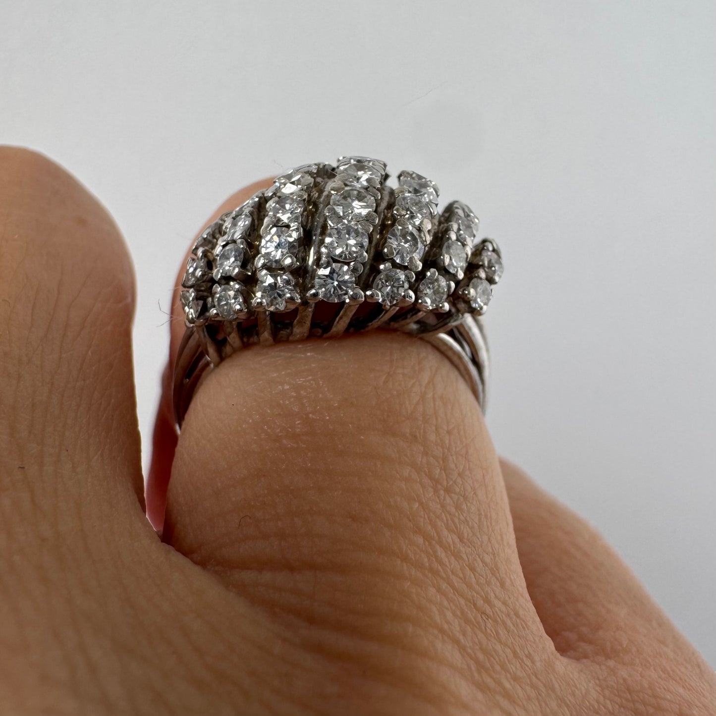18K gold diamond ring with curved rows of brilliant stones.