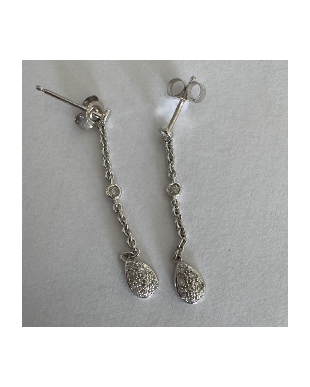 14K gold drop earrings featuring a delicate chain design with sparkling teardrop pendants.
