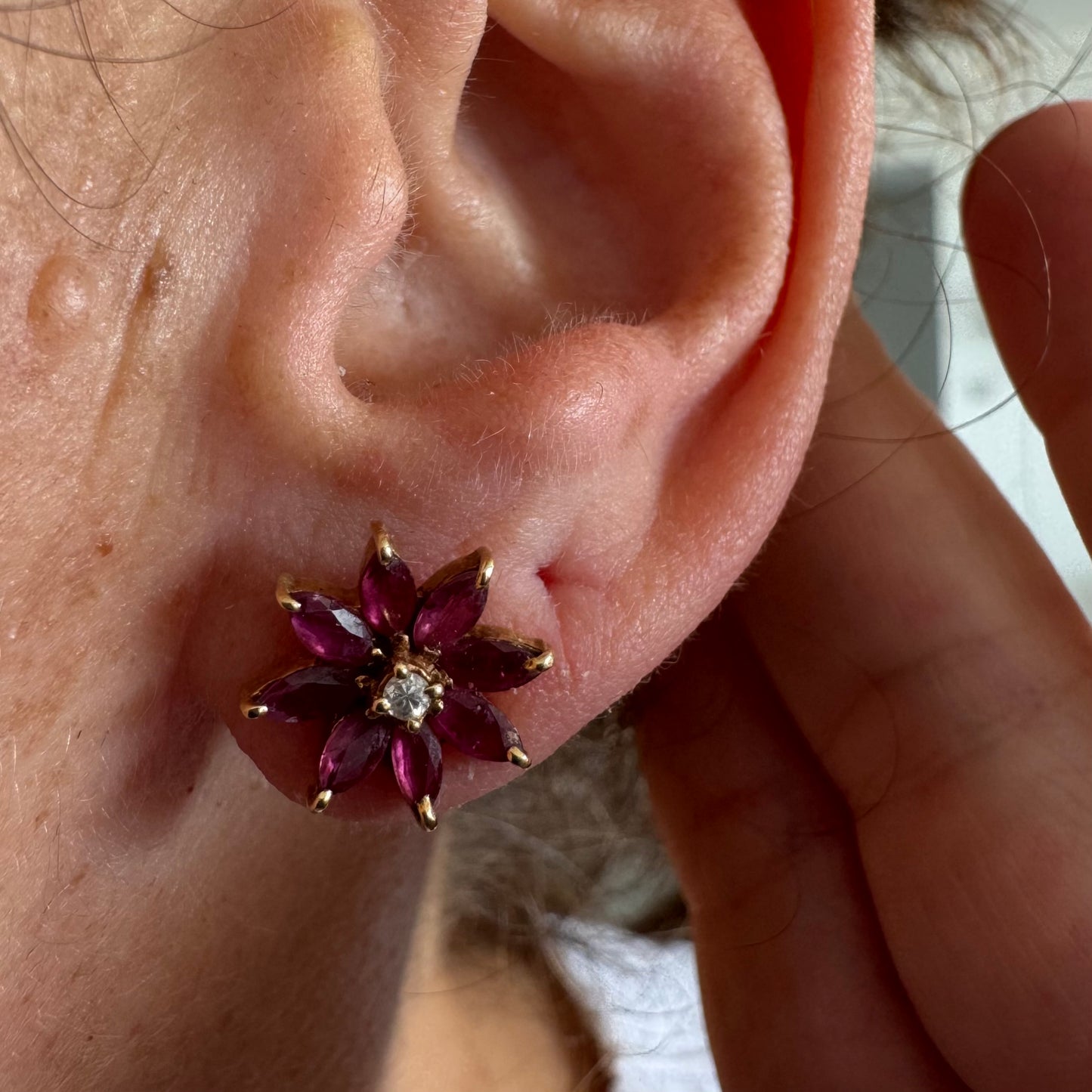 14K gold floral earrings set with marquise-cut Rubies and a small Diamond at the center