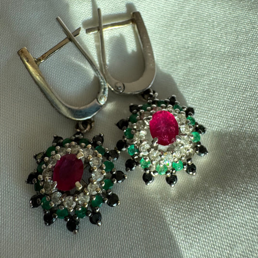 14K white gold drop earrings set with white and black Diamonds, Emeralds and a central Ruby