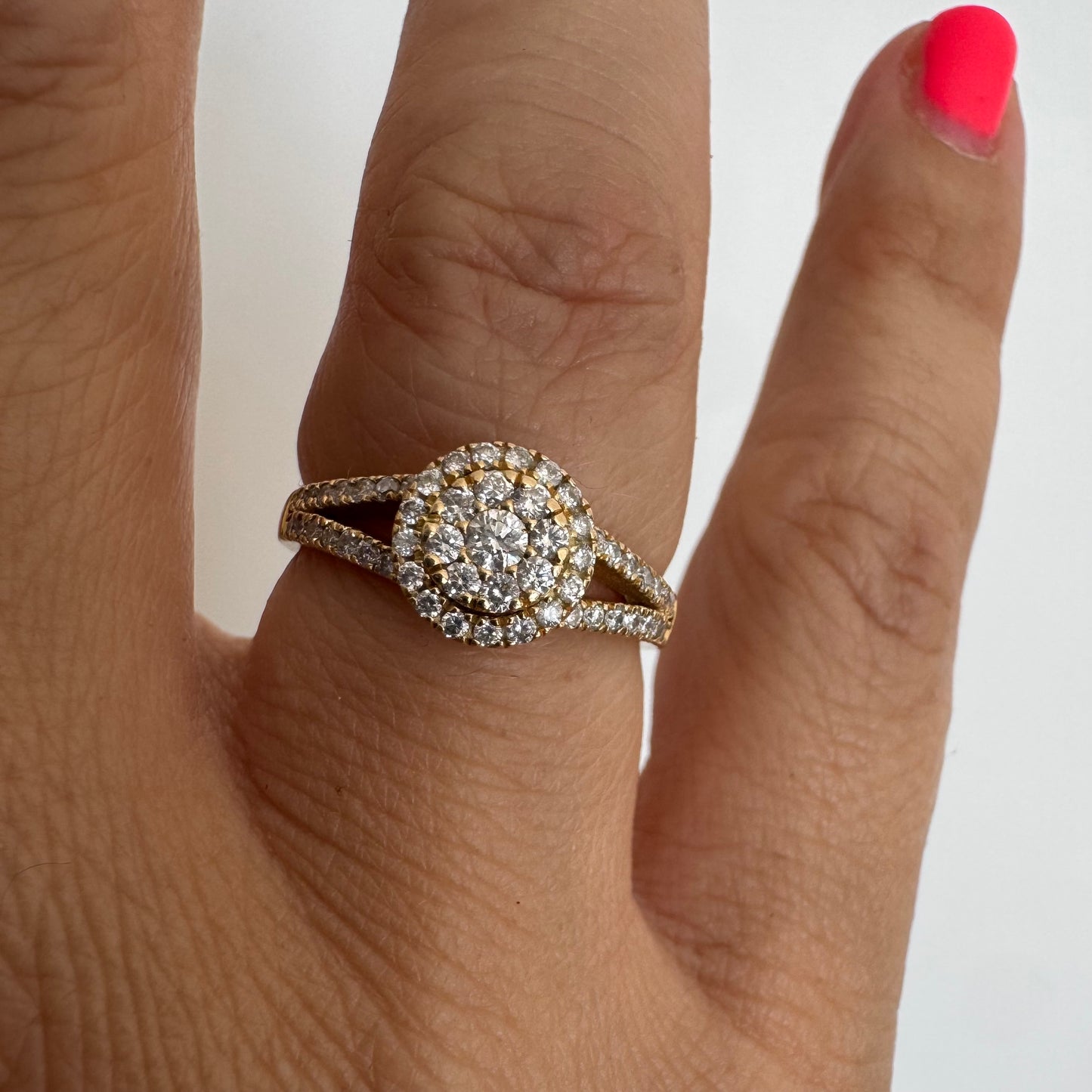 14K gold ring set with Diamonds in a sparkling halo design.