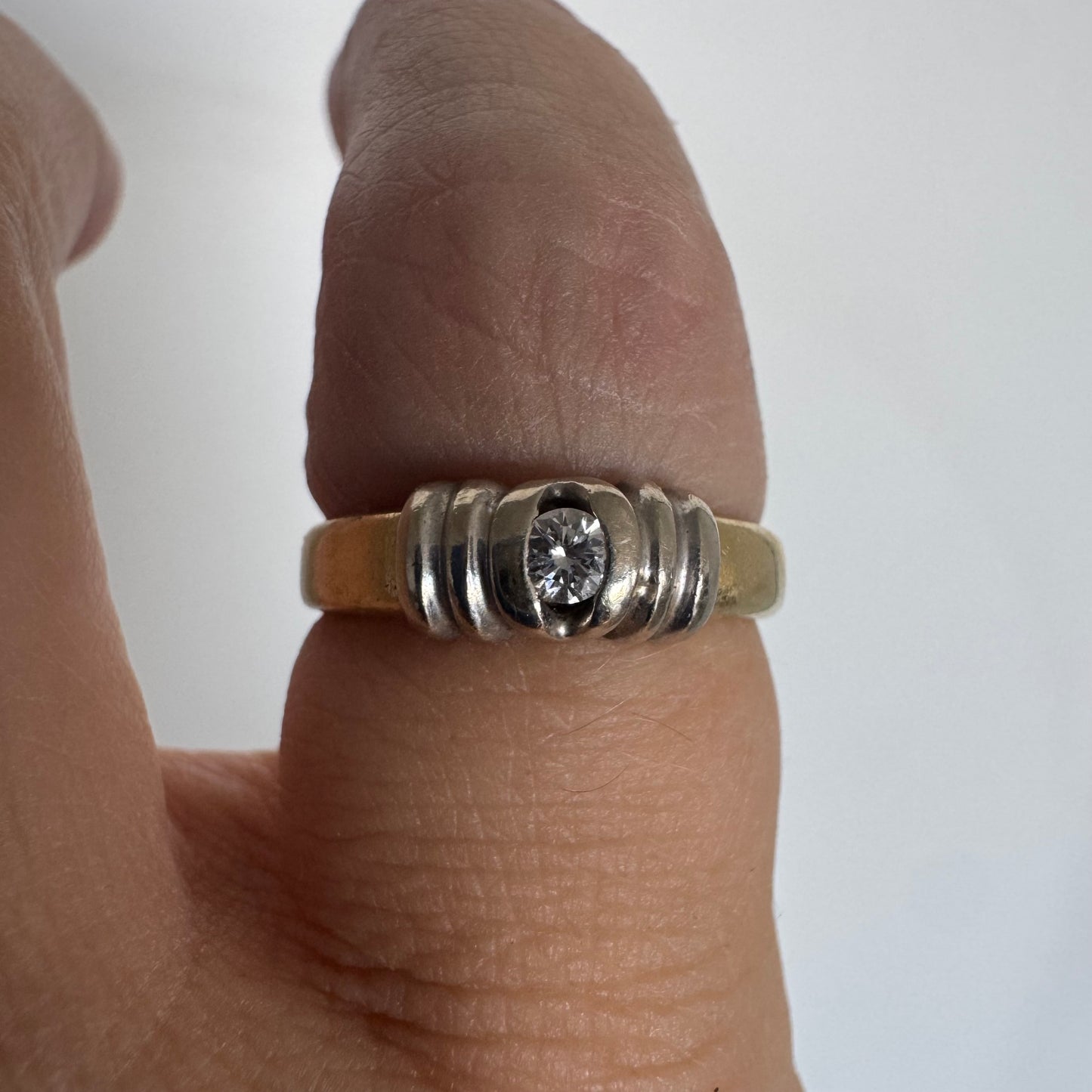 14K two-tone gold ring set with a central Diamond in a clean and refined design