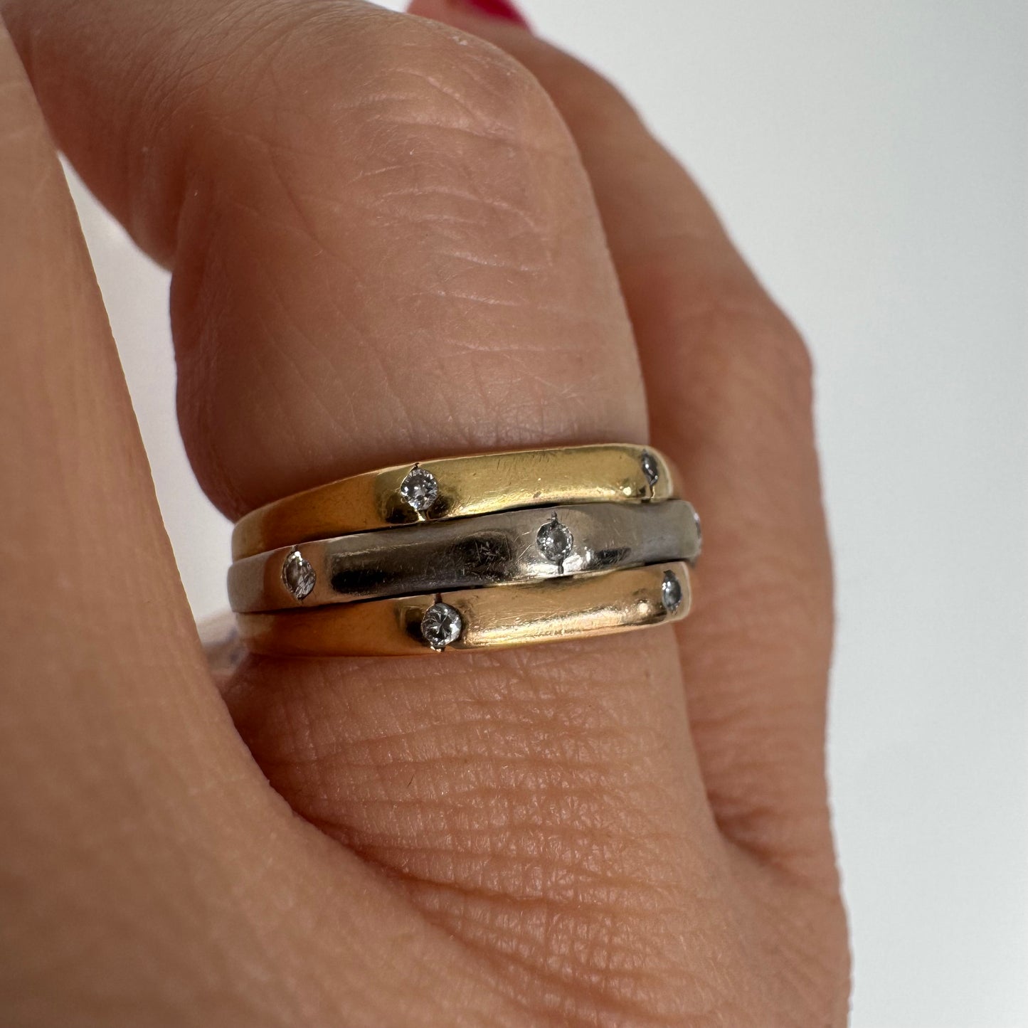 18K gold ring crafted in yellow, white, and rose gold, featuring a triple-band design set with Diamonds