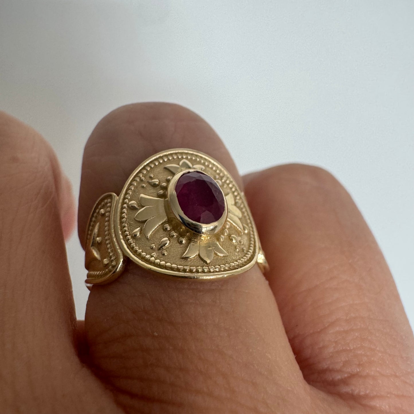 14K gold ring set with an oval Ruby