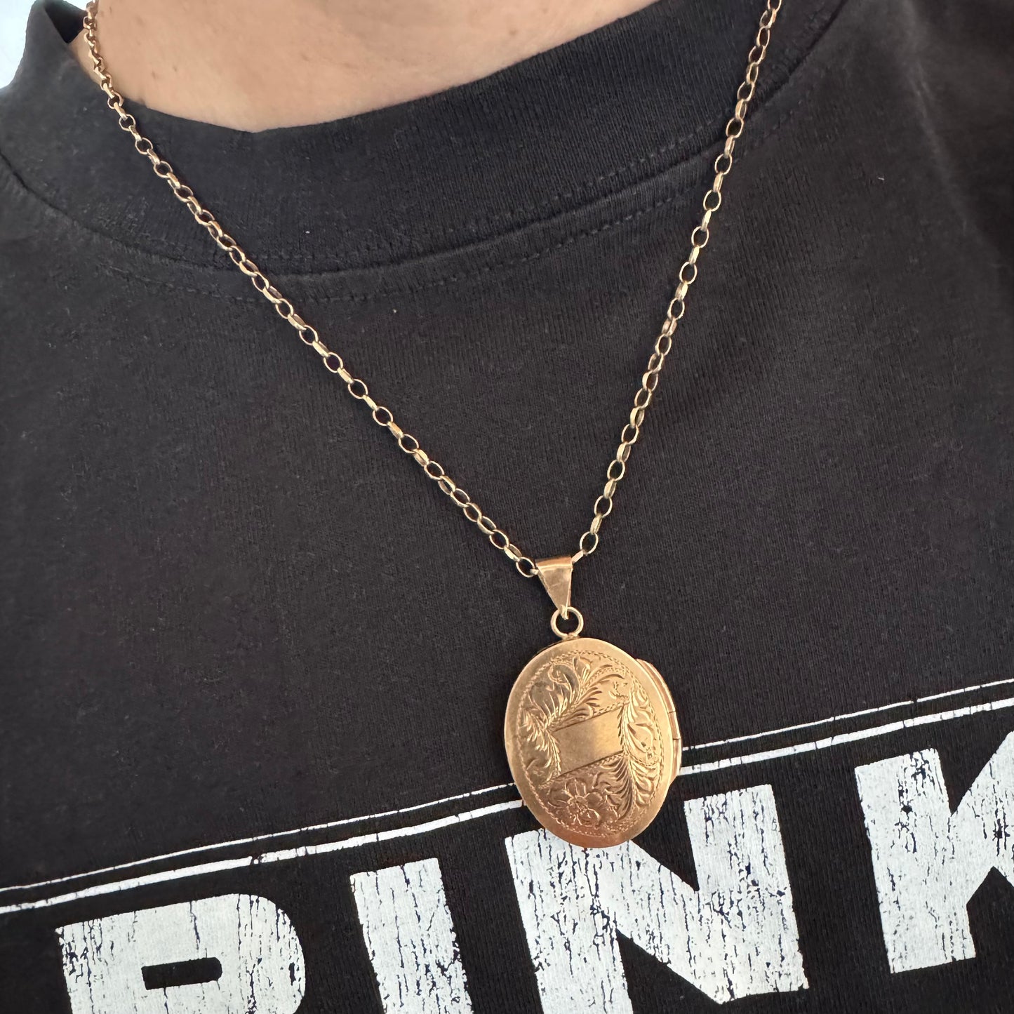 14K gold oval locket pendant delicately hand-engraved with floral motifs