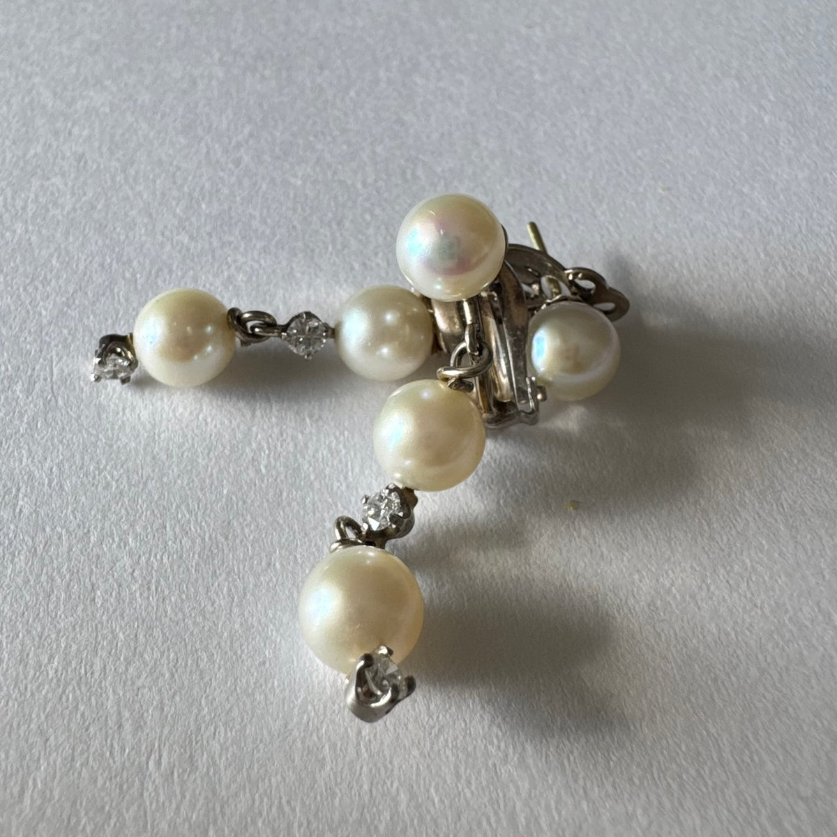 14K gold elegant drop earring set with three soft creamy Pearls connected by round brilliant Diamonds
