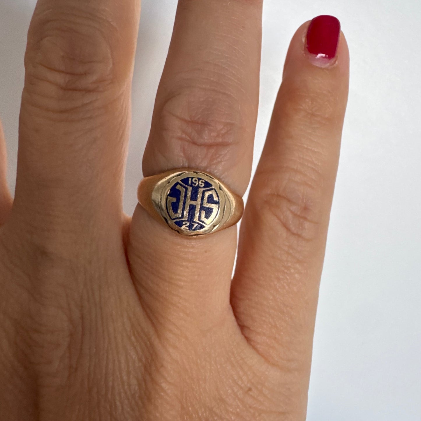 14K gold signet ring featuring an oval face with dark enamel and bold engraved initials at the center.