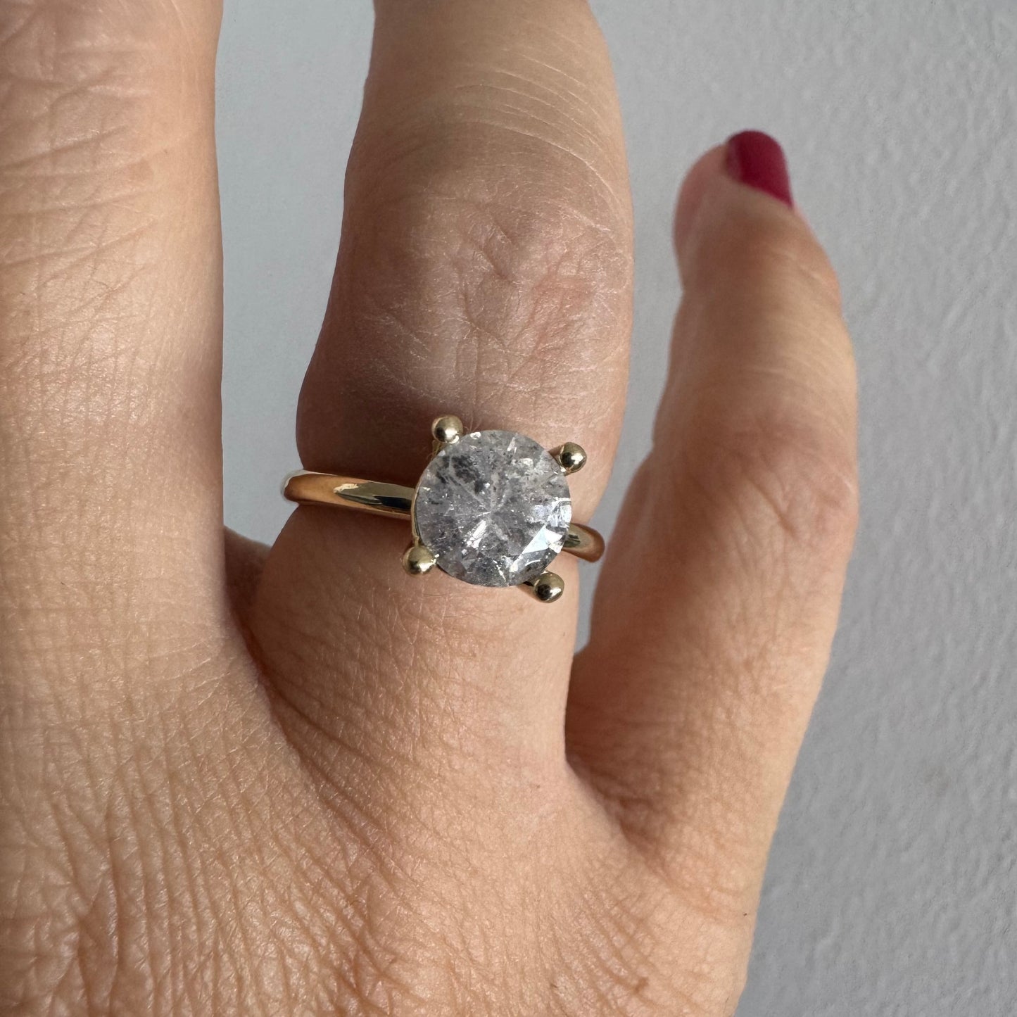 14K gold solitaire ring set with a central round Diamond