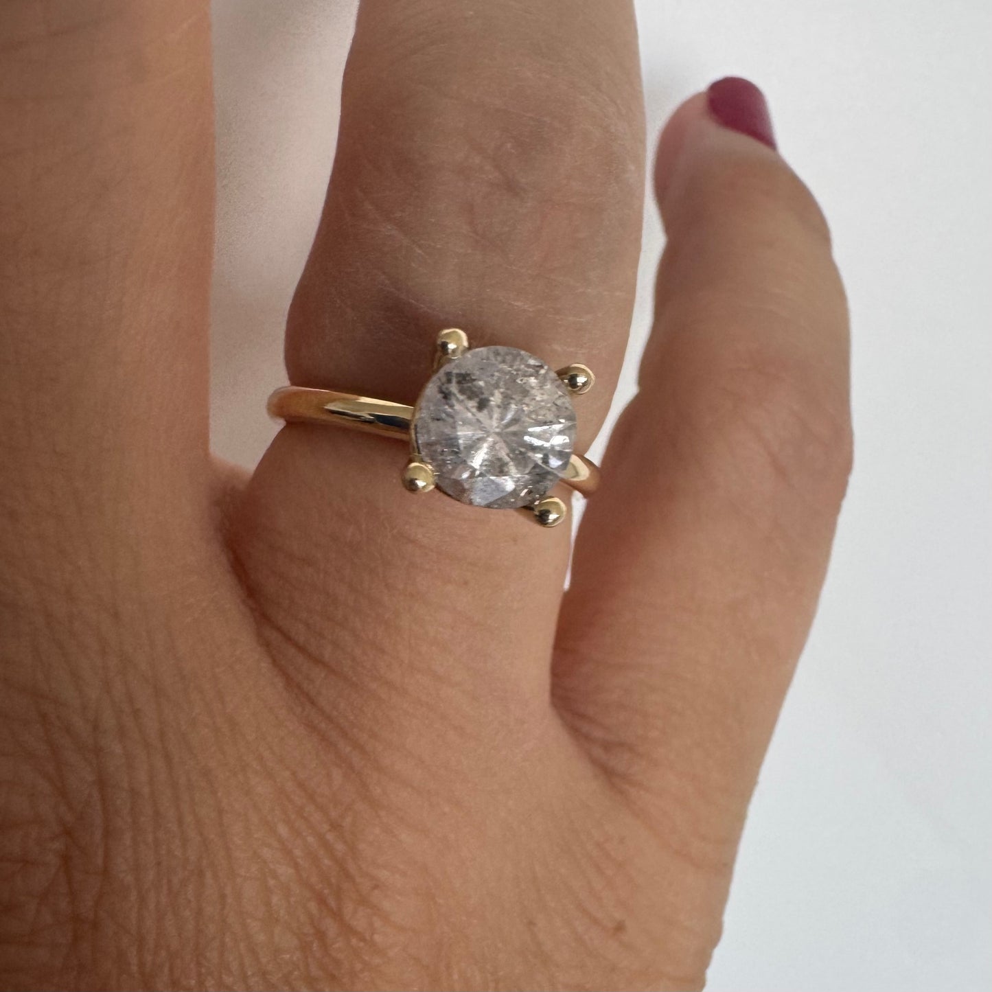 14K gold solitaire ring set with a central round Diamond