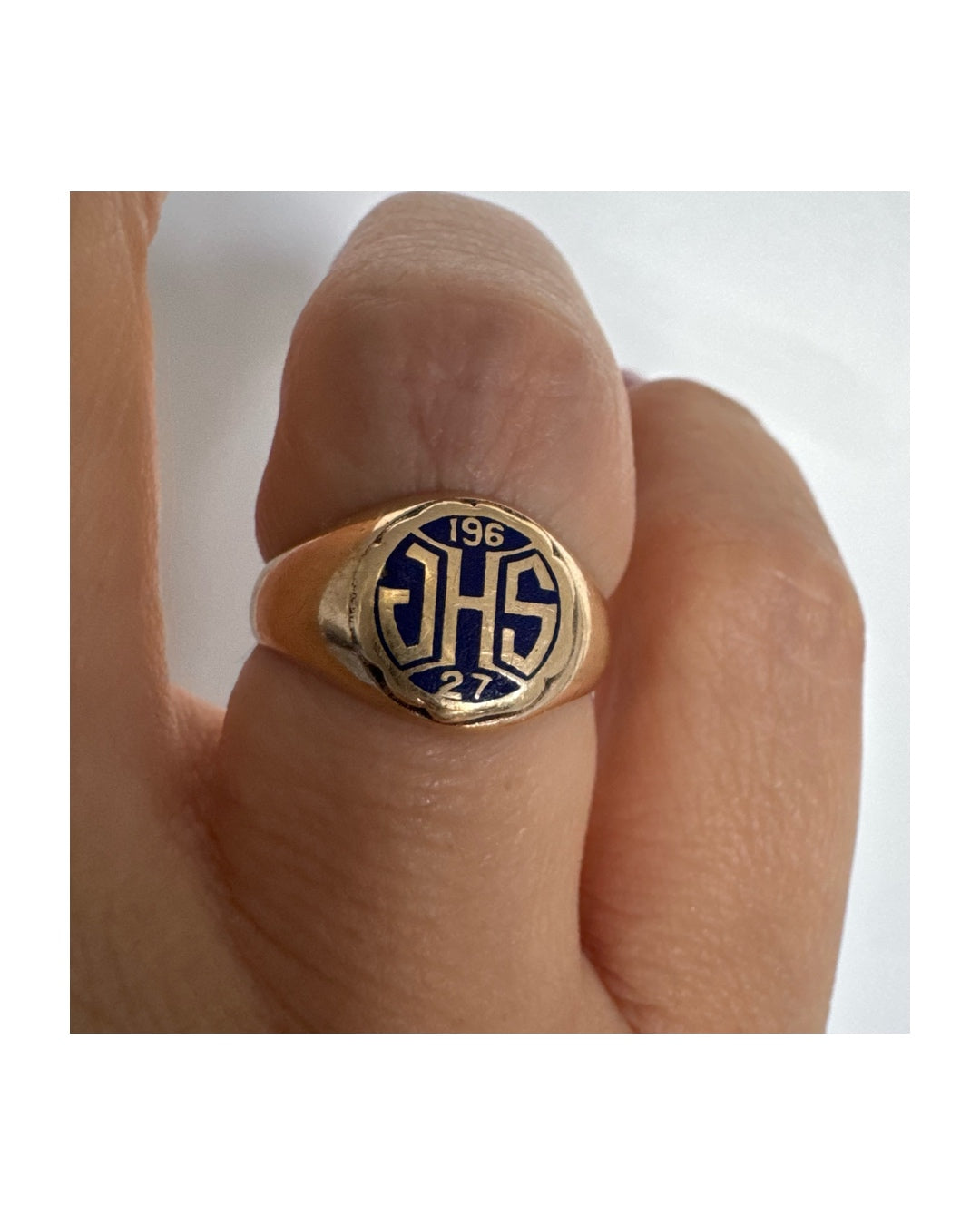 14K gold signet ring featuring an oval face with dark enamel and bold engraved initials at the center.