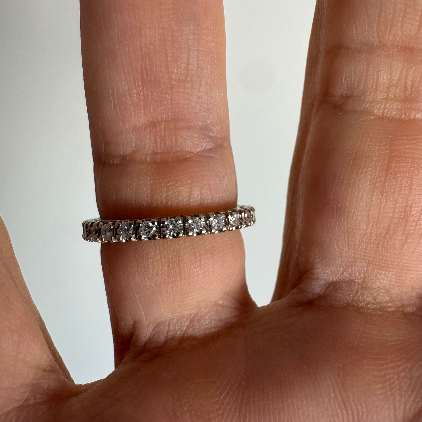Classic 14K gold eternity ring set with a full circle of sparkling Diamonds