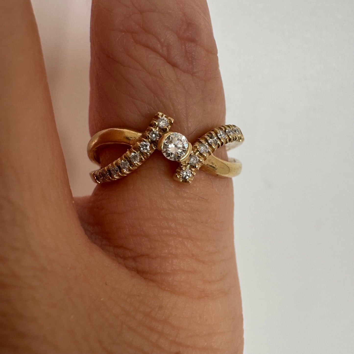 14K gold ring set with a central Diamond and sparkling side Diamonds