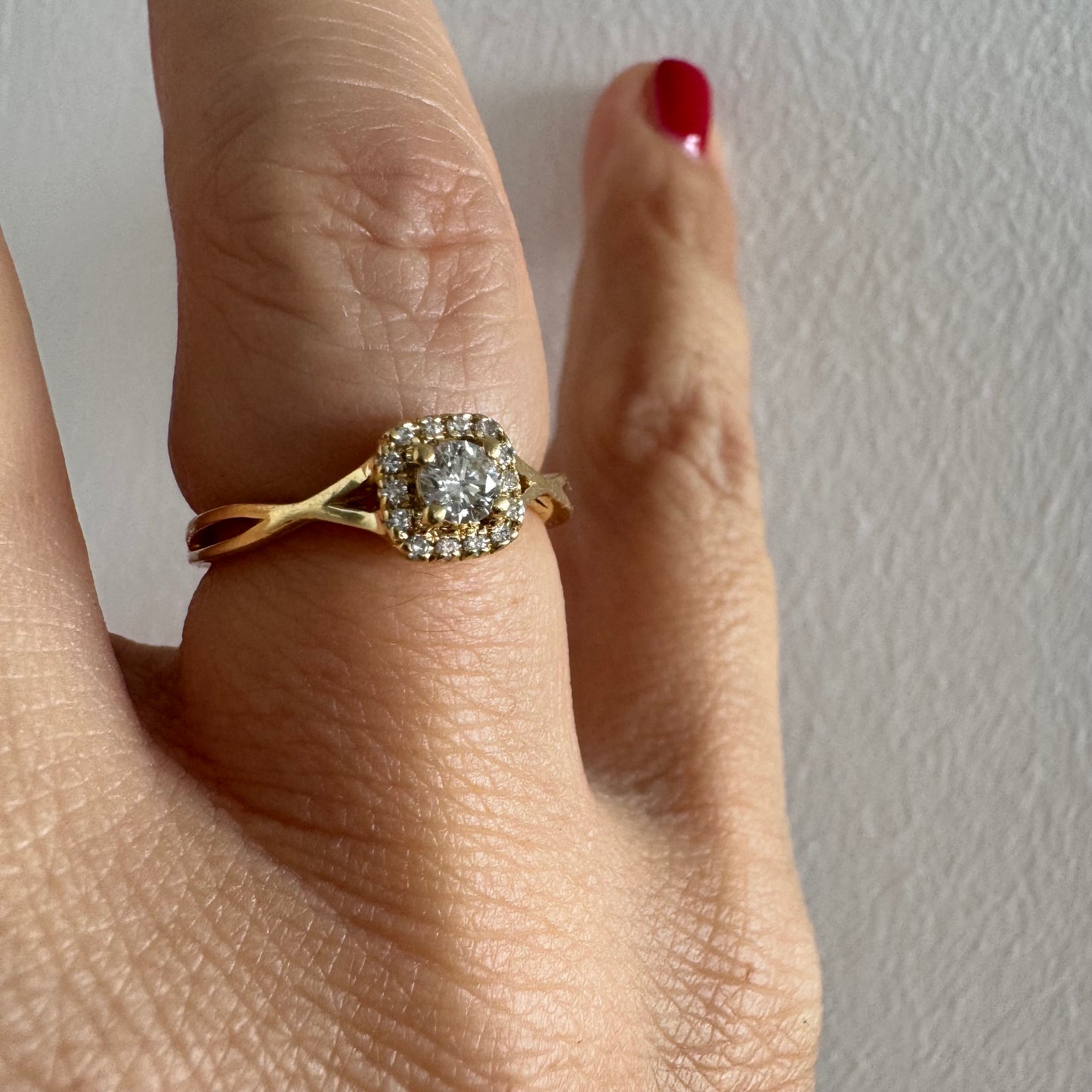 14K gold ring set with a central Diamond surrounded by small Diamonds
