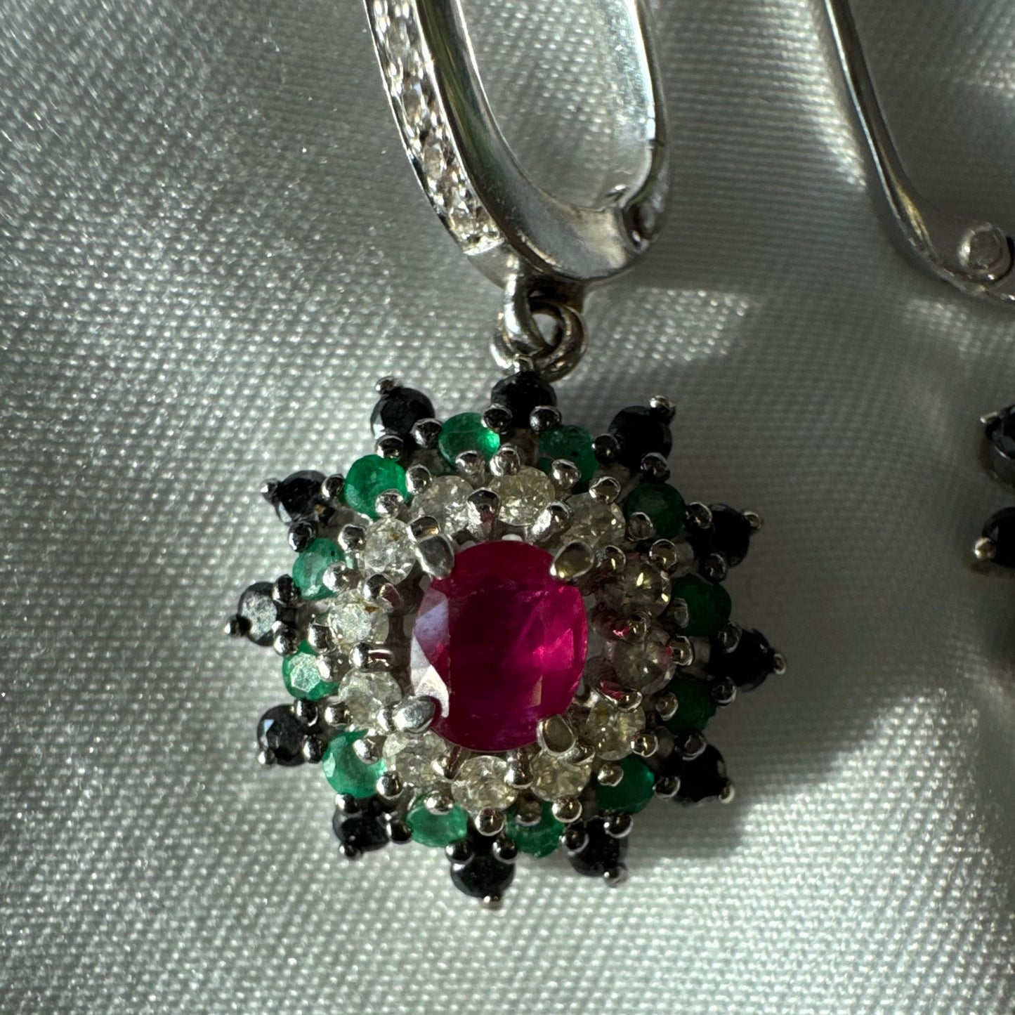 14K white gold drop earrings set with white and black Diamonds, Emeralds and a central Ruby