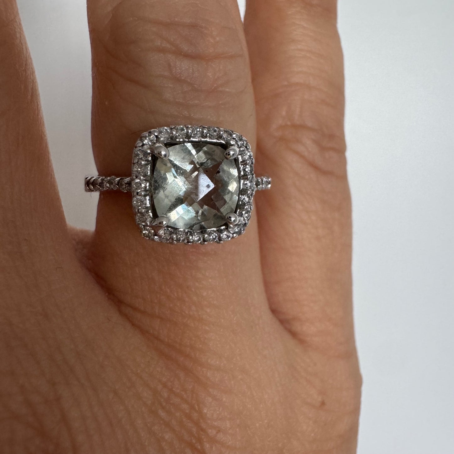 14K white gold ring featuring a cushion-cut light blue Aquamarine set in a sparkling double halo of round-cut Diamonds.
