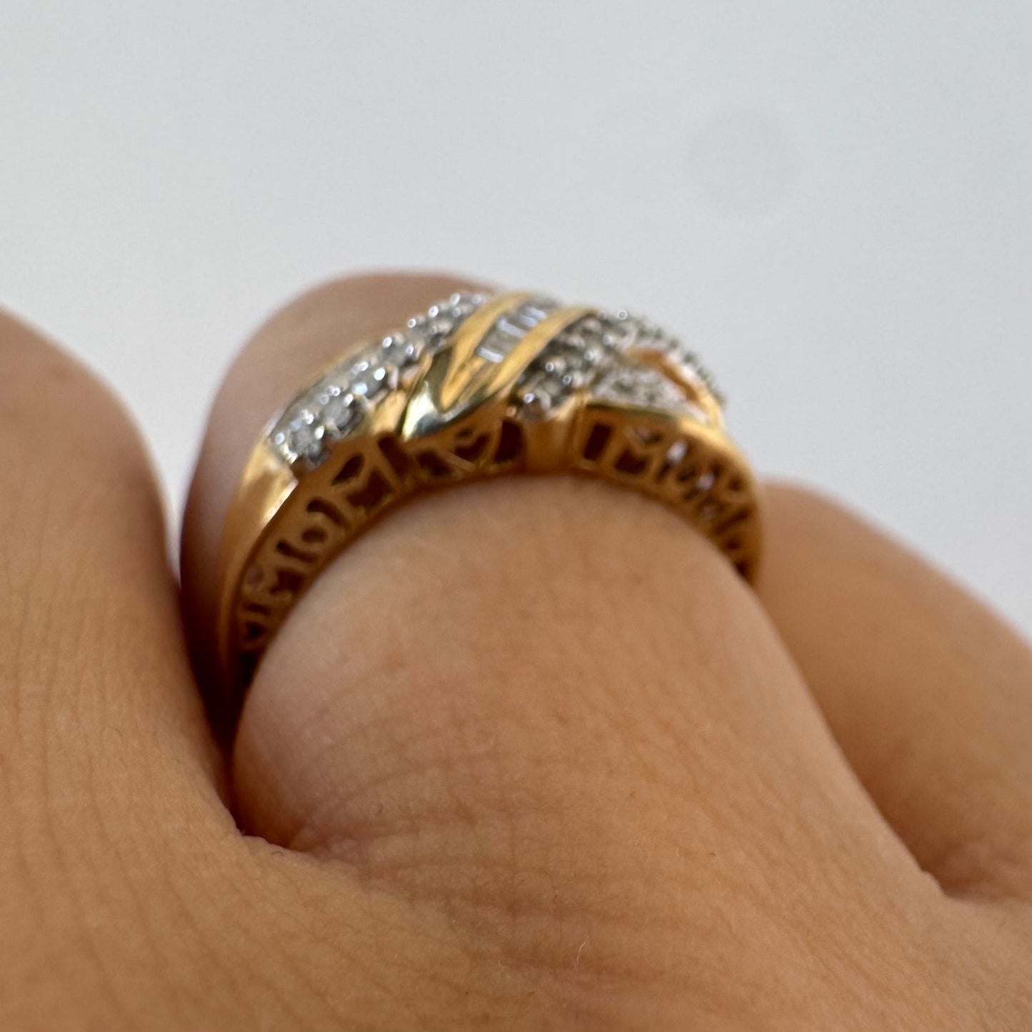 10K gold ring set with round-cut Diamonds and a central row of baguette Diamonds.