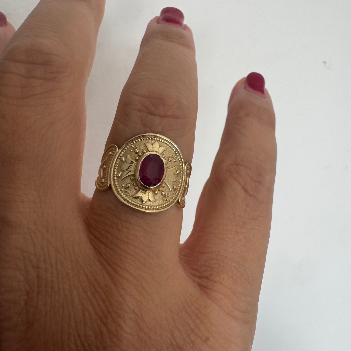 14K gold ring set with an oval Ruby