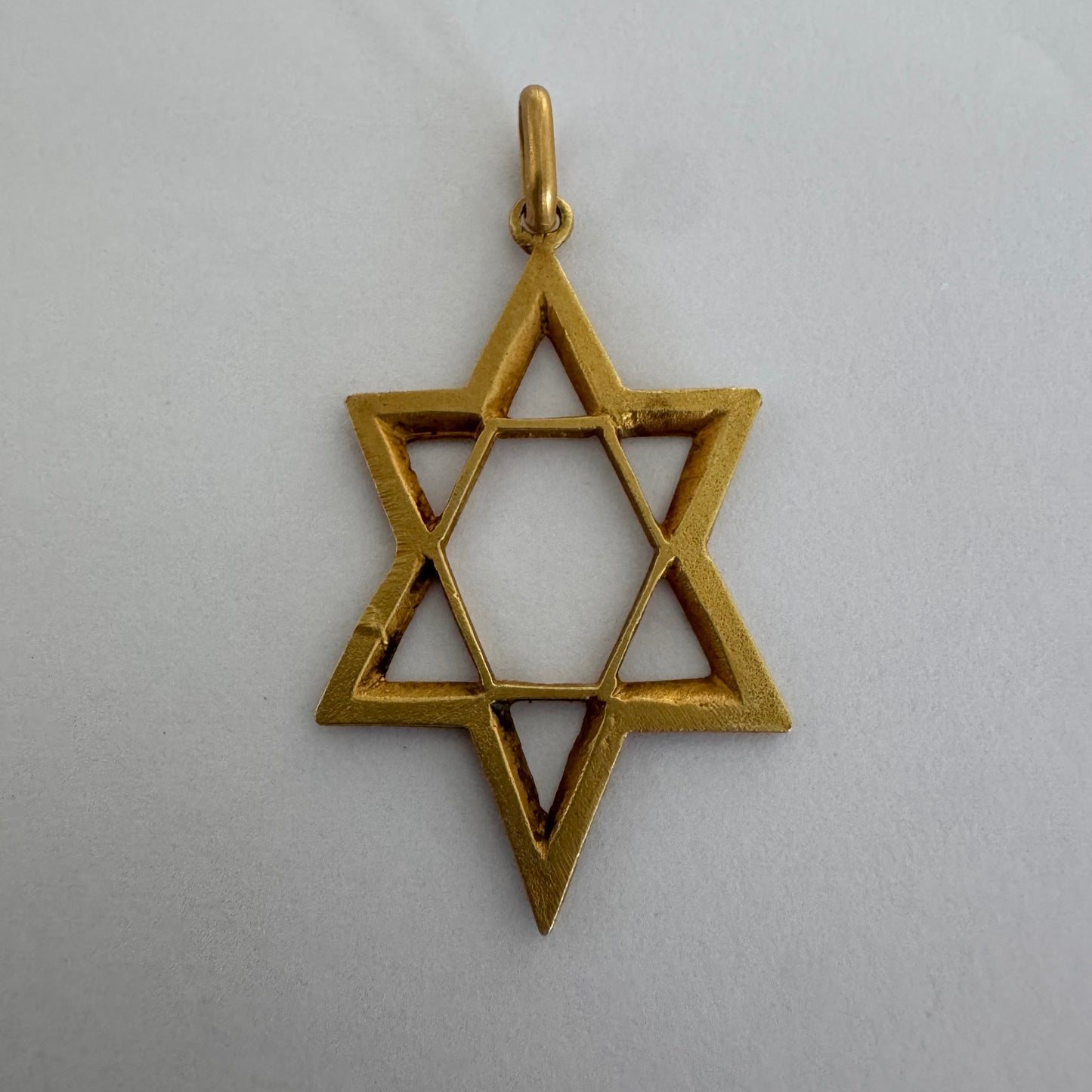 14K gold Star of David pendant with textured detailing and an open design.