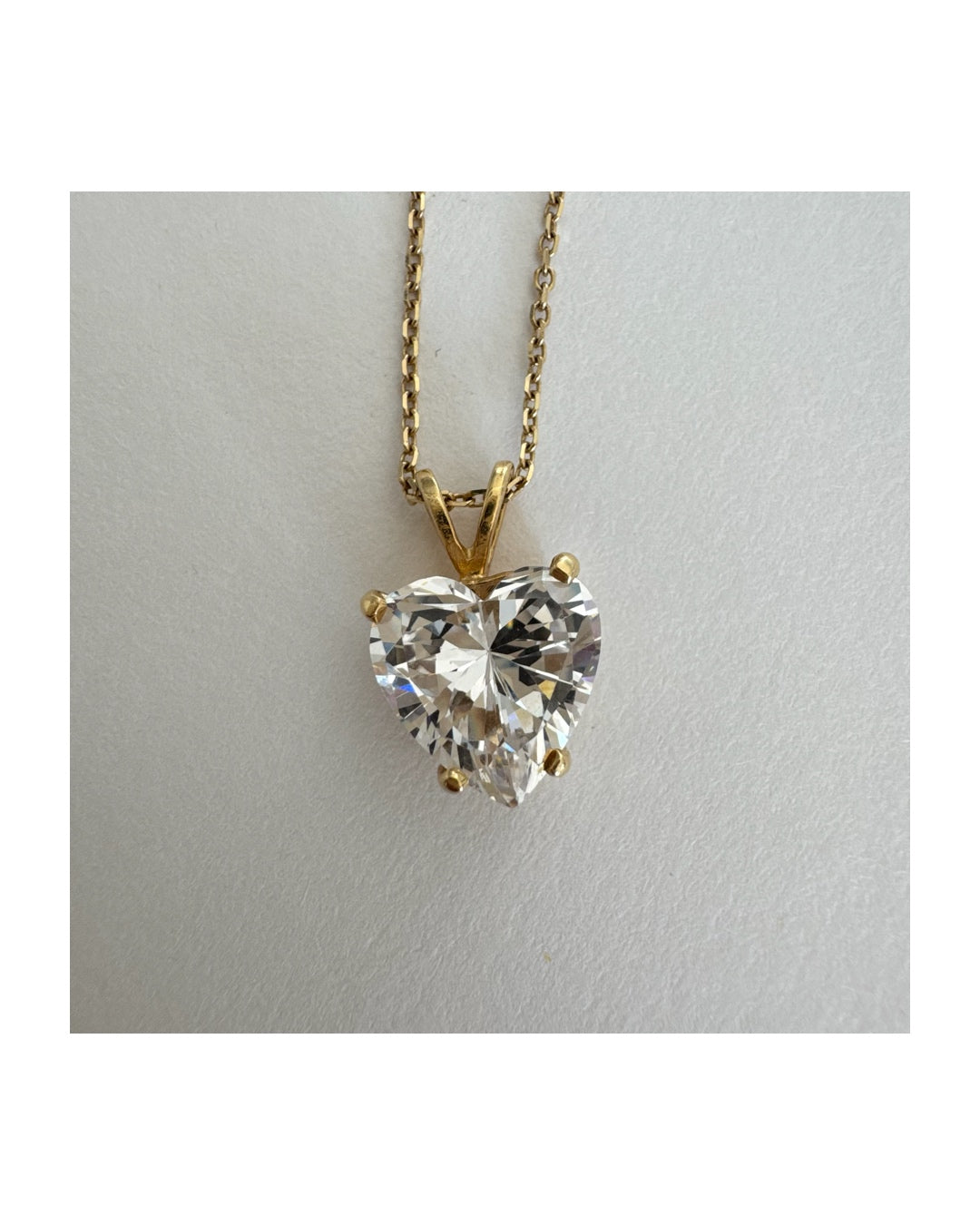 14K gold Heart Pendant set with a brilliant heart-cut clear stone.