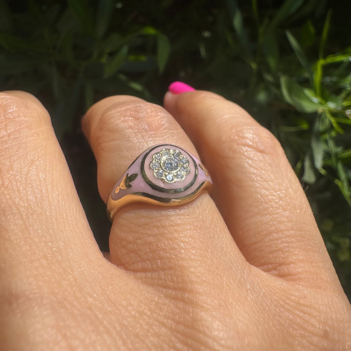 14K gold ring set with soft pink enamel & Diamonds with floral motif at the center.