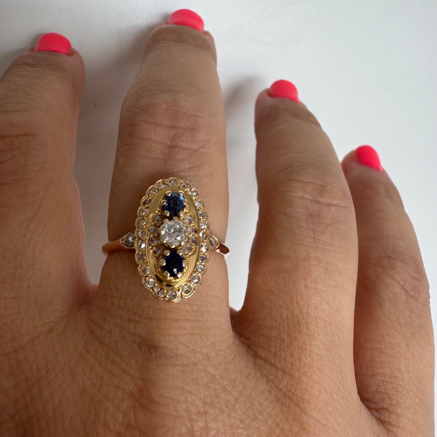 14K gold ring set with Diamonds and deep blue Sapphires in a classic oval design.