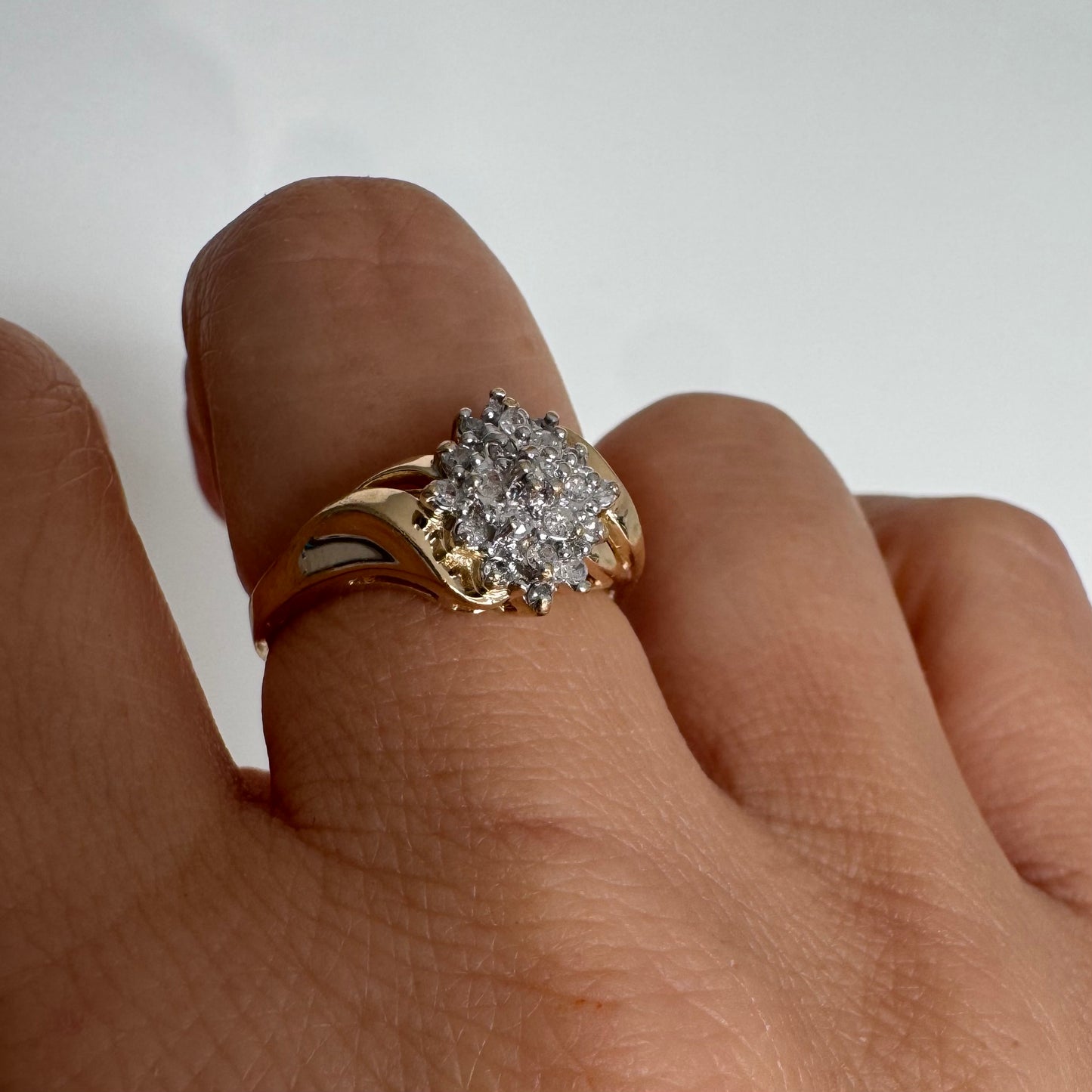 10K gold ring set with Diamonds, featuring a classic design with soft, flowing curves.
