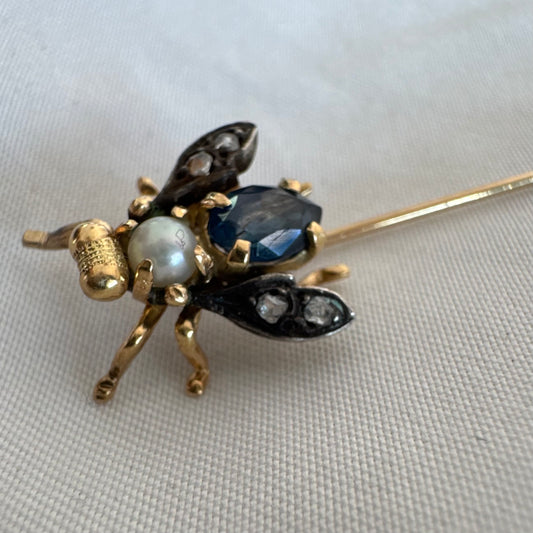 14K gold insect stick pin set with sapphire, seed pearl, and small diamonds.