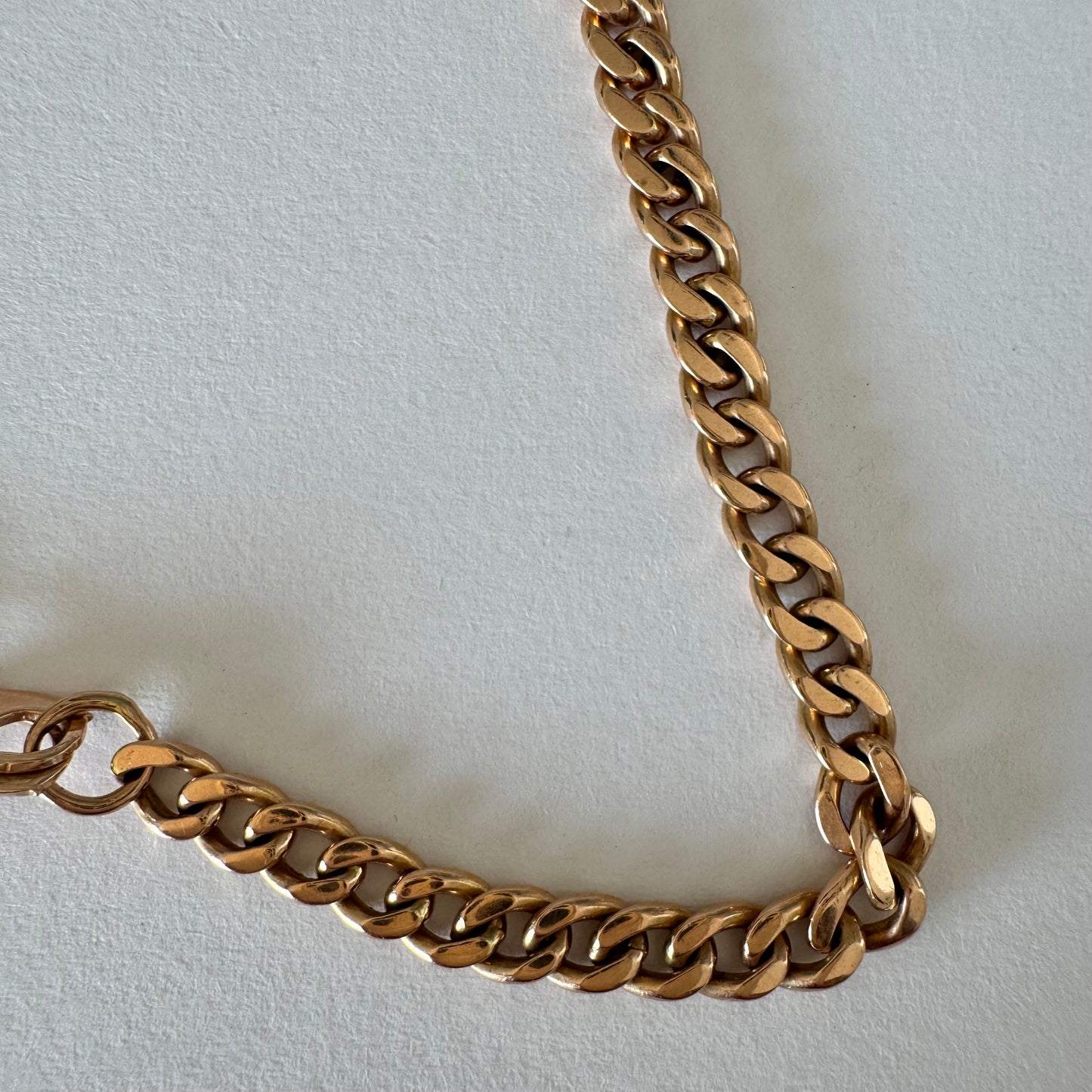 14K gold bracelet featuring a classic chain-link design with a sleek, elegant presence on the wrist.