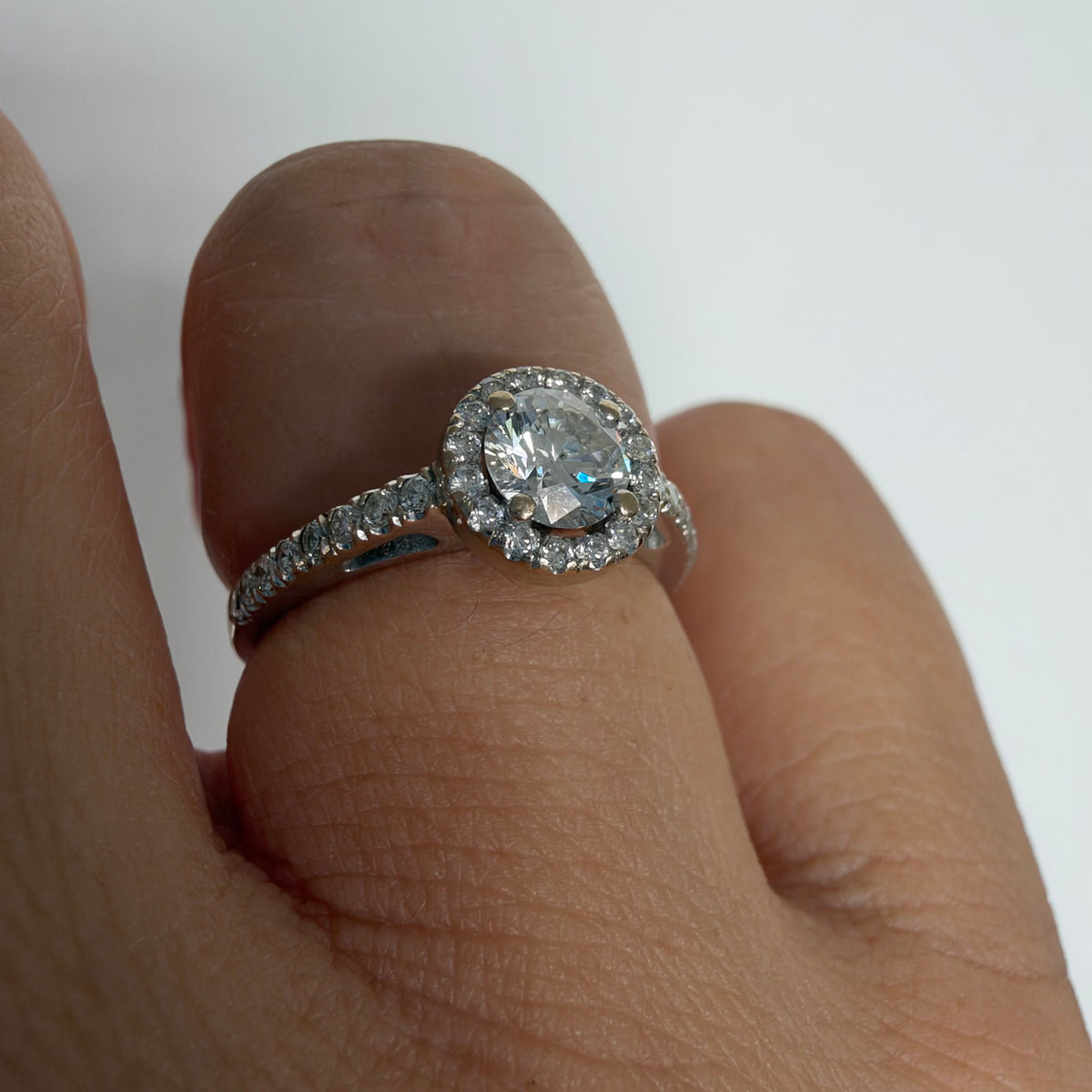 14K white gold vintage ring with a round brilliant-cut diamond and diamond halo