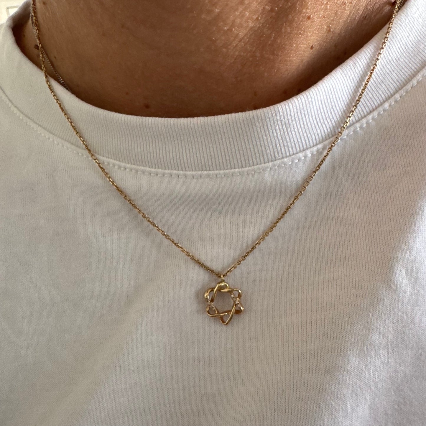 14K gold “Star of David” pendant with a sculptural open design.