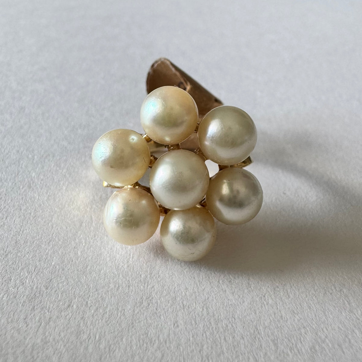 14K gold ring set with seven round Pearls in a bold floral cluster