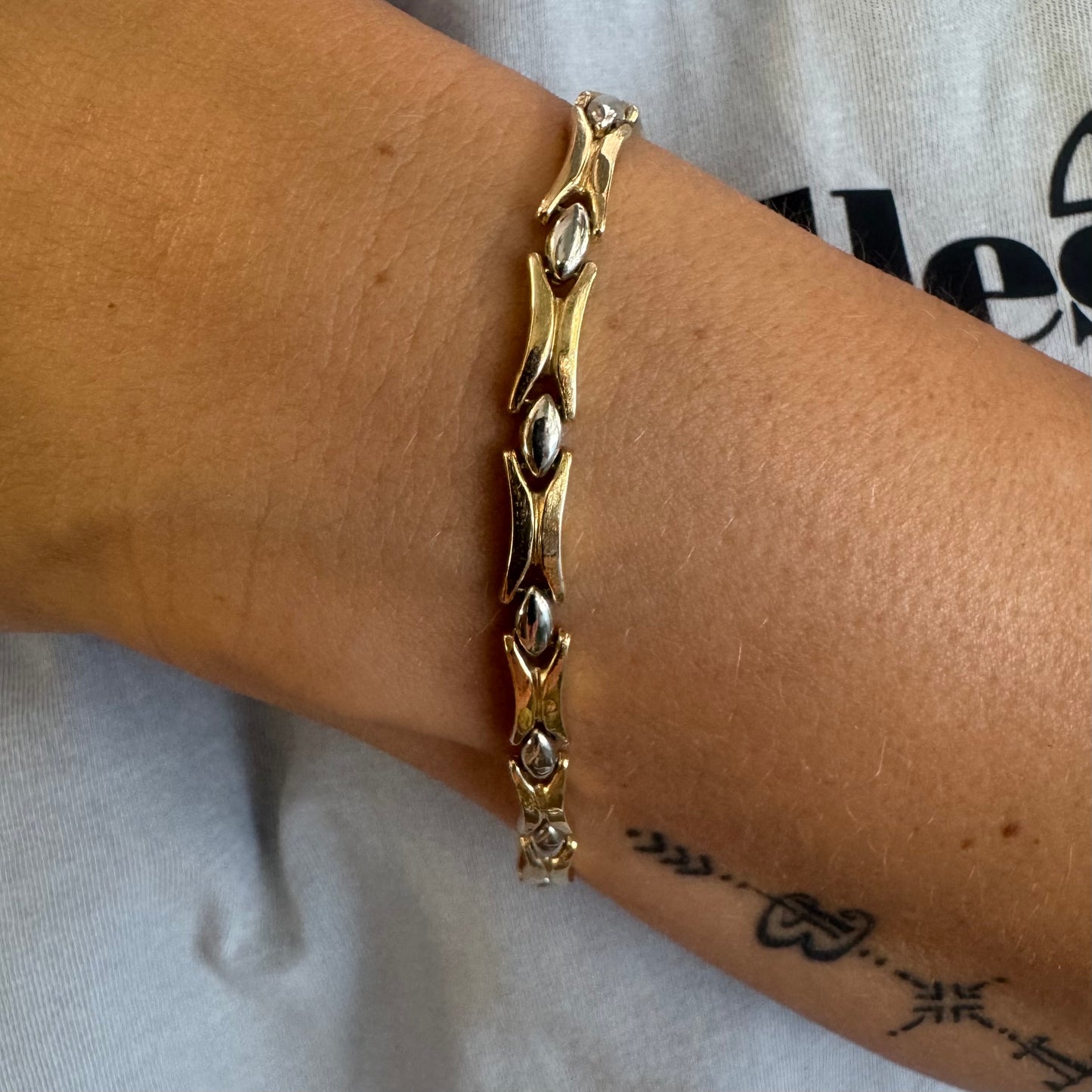 14K gold bracelet featuring a bold geometric design with X-shaped