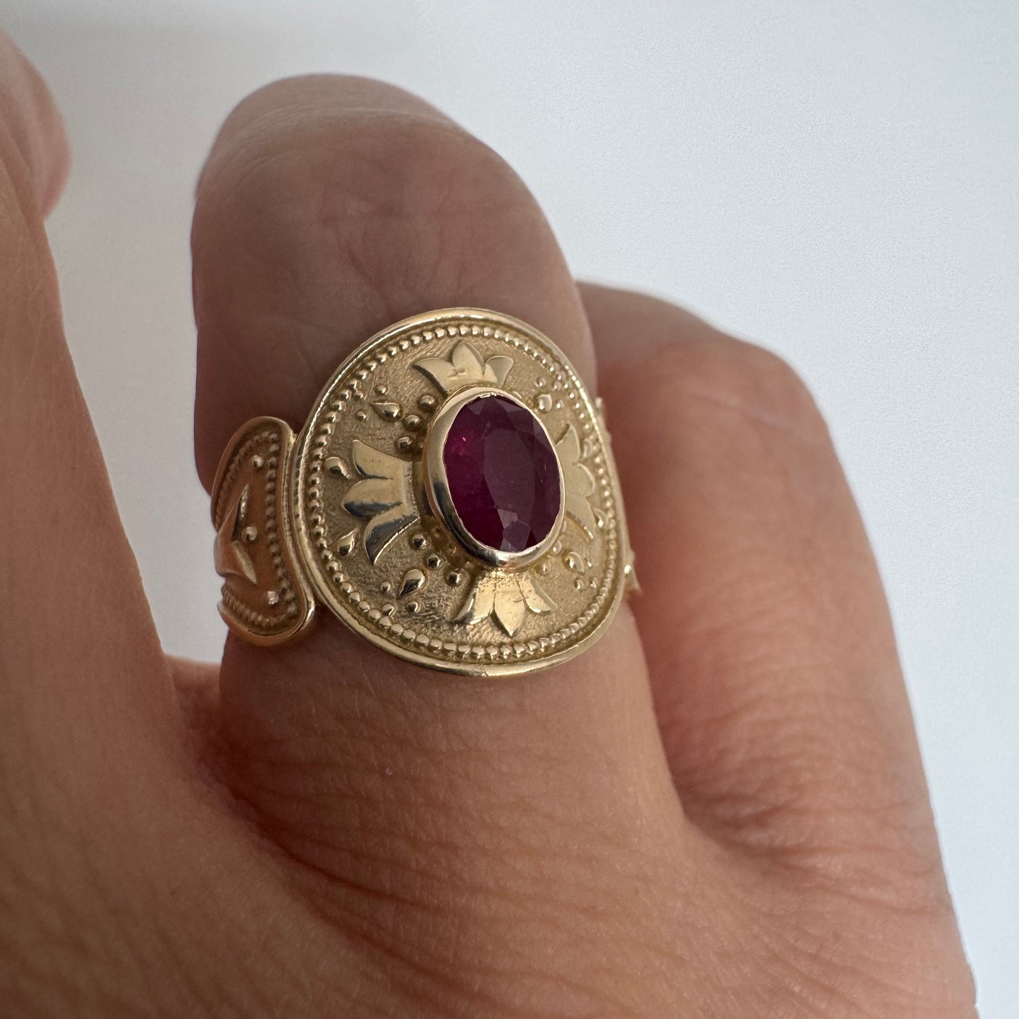 14K gold ring set with an oval Ruby