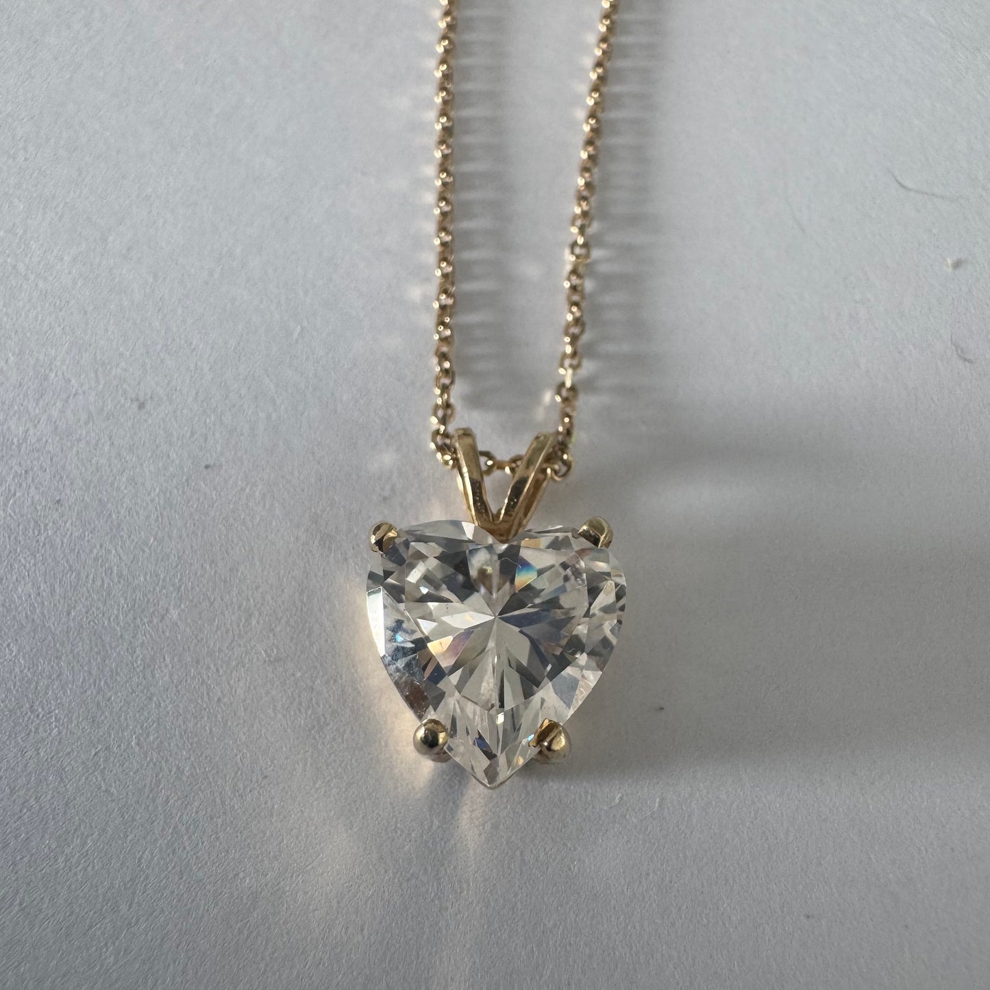 14K gold Heart Pendant set with a brilliant heart-cut clear stone.