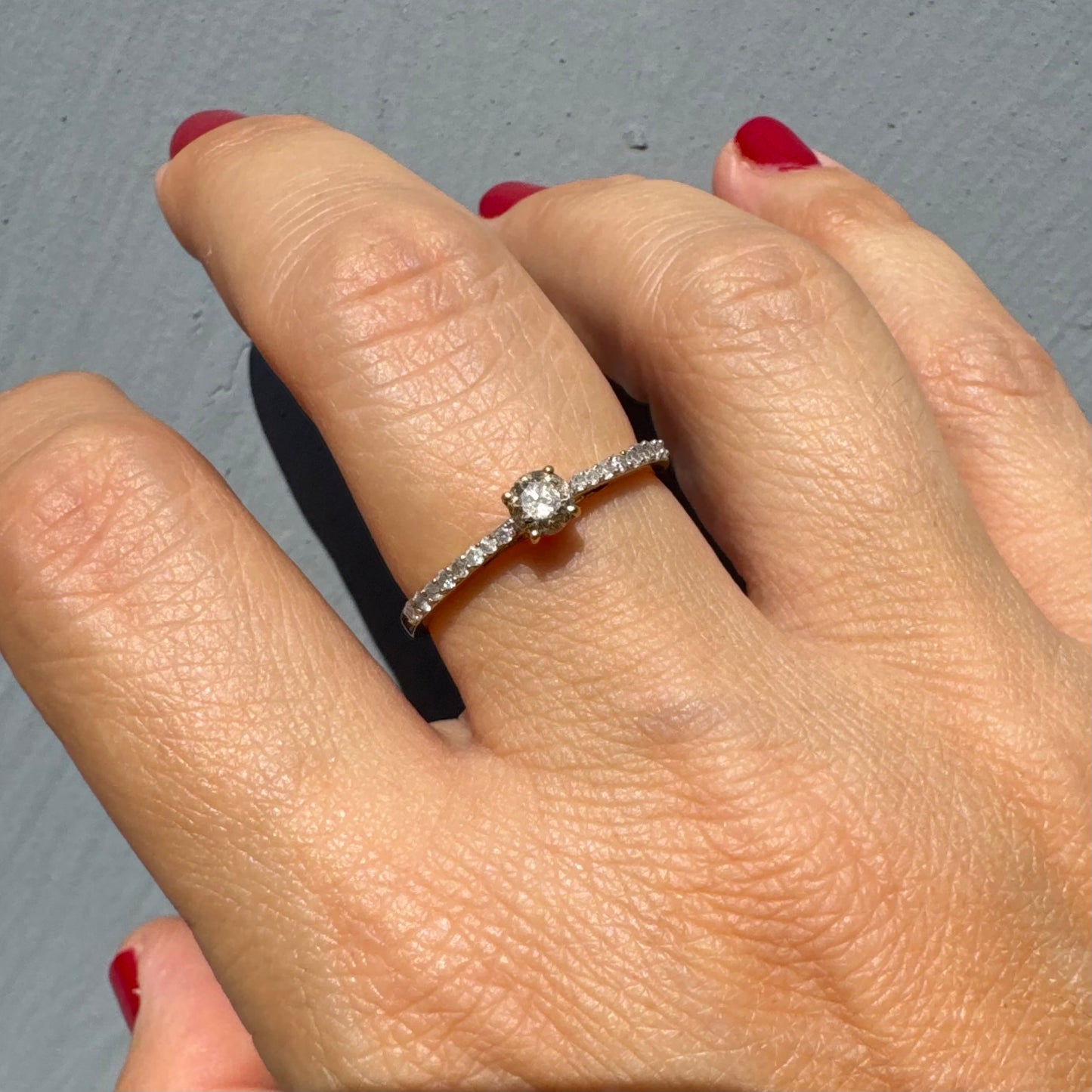 9K gold ring set with a central Diamond and sparkling Diamonds along the band