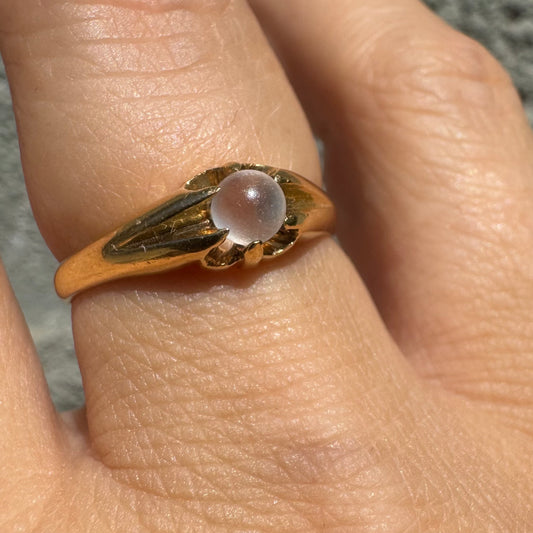 18K yellow gold ring featuring a smooth round Moonstone set in a delicate floral-inspired design.