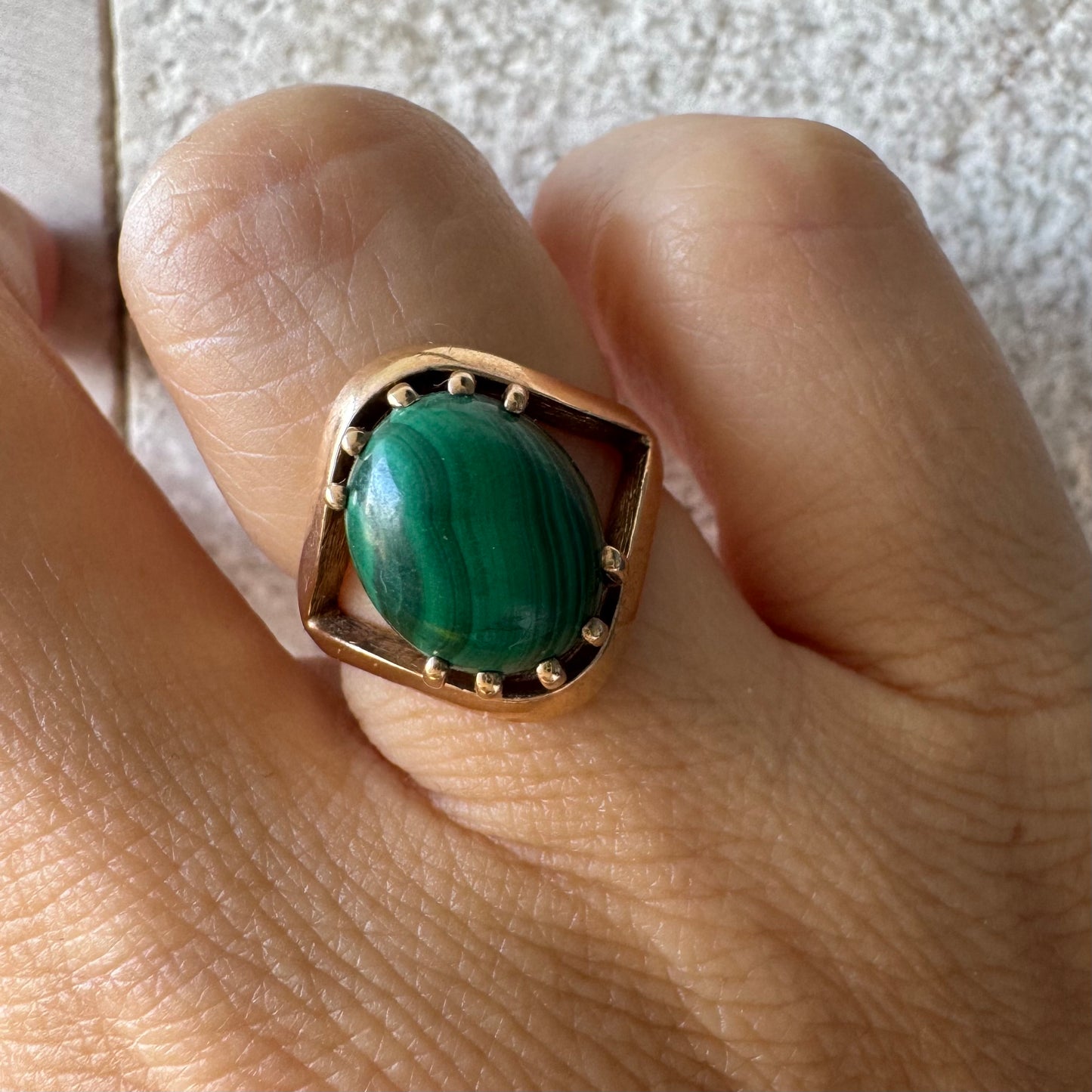 14K gold ring set with a polished Malachite cabochon