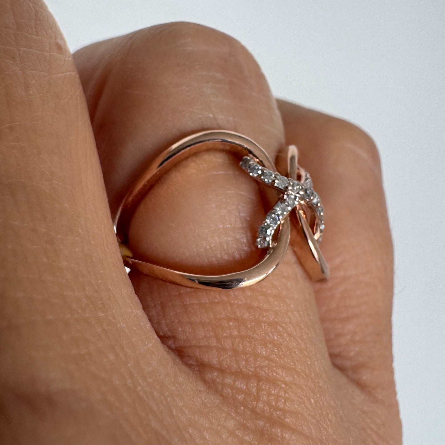 10K rose gold ring set with natural Diamonds in a flowing & artistic design.