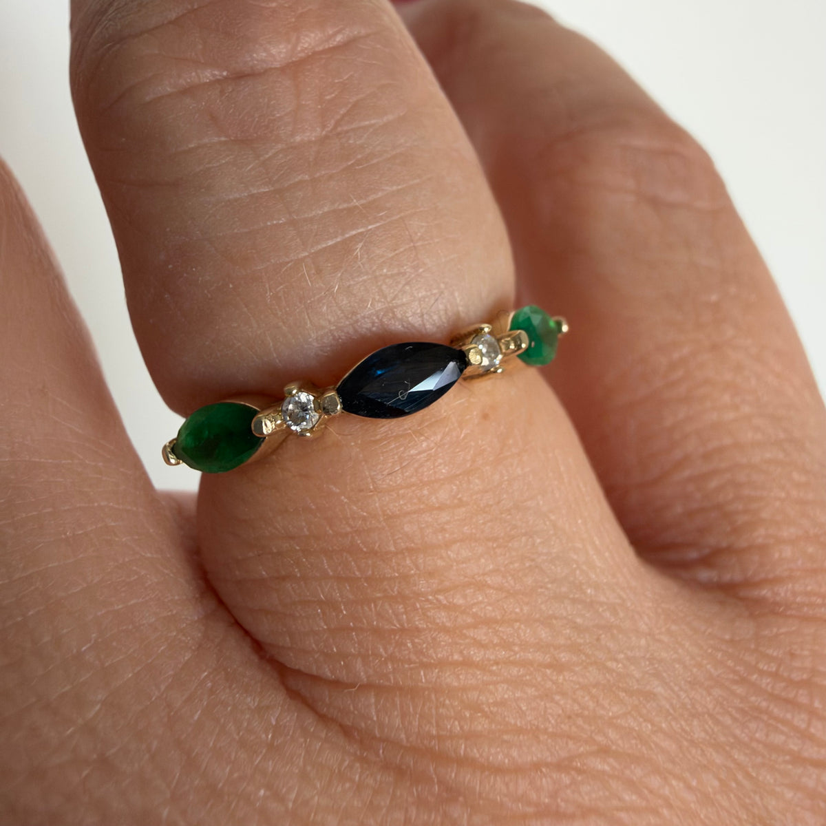 14K yellow gold vintage ring with a marquise-cut sapphire and emeralds