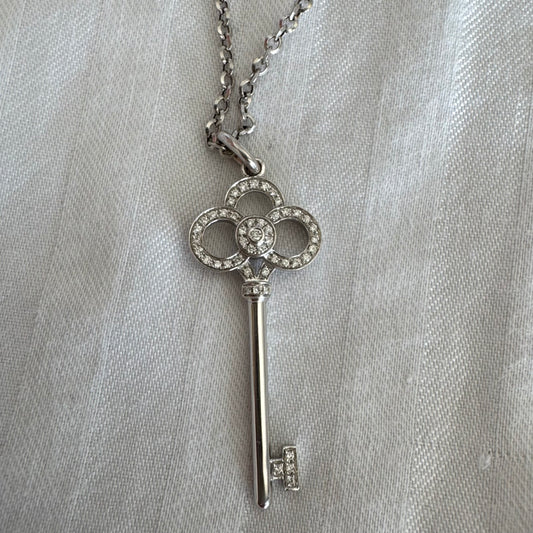 Iconic Tiffany & Co. key pendant crafted in white gold and set with delicate Diamonds.