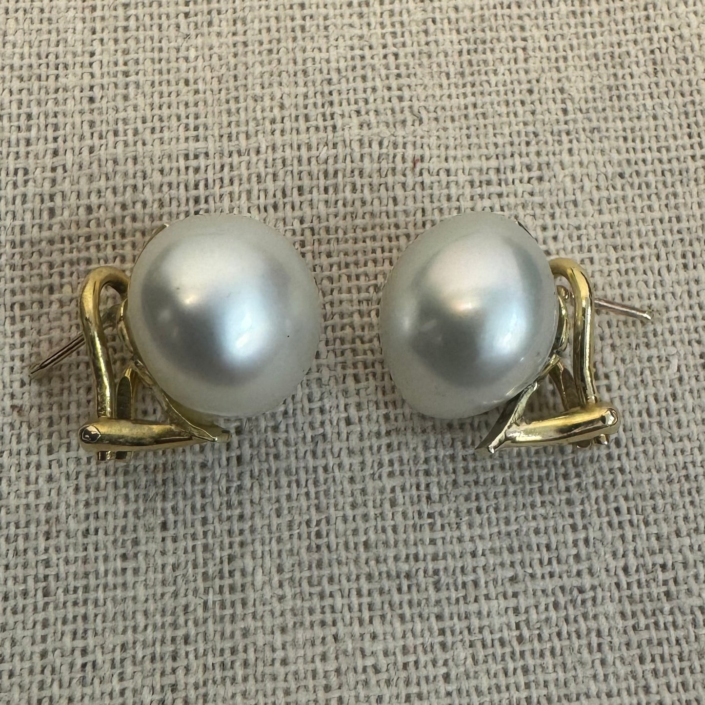 14K gold stud earrings set with large & luminous white Pearls.