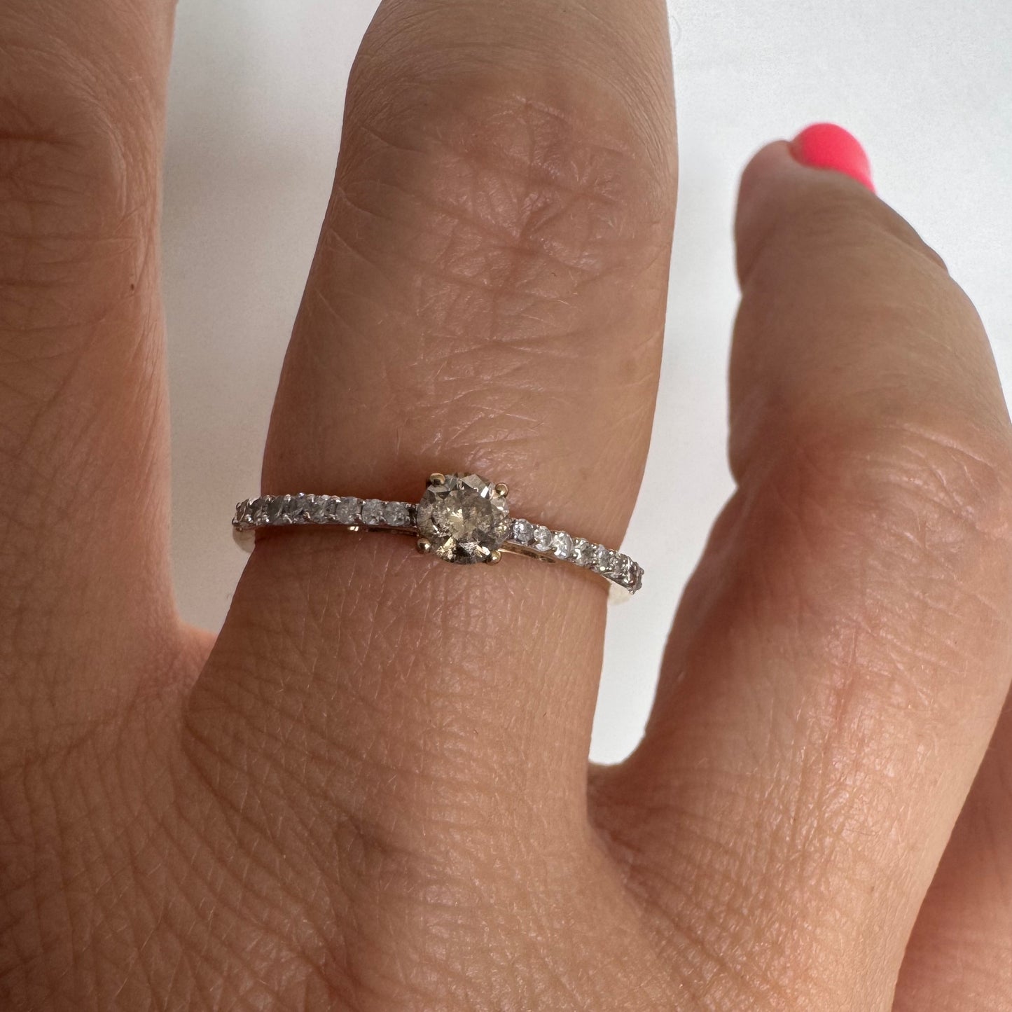 9K gold ring set with a central Diamond and sparkling Diamonds along the band