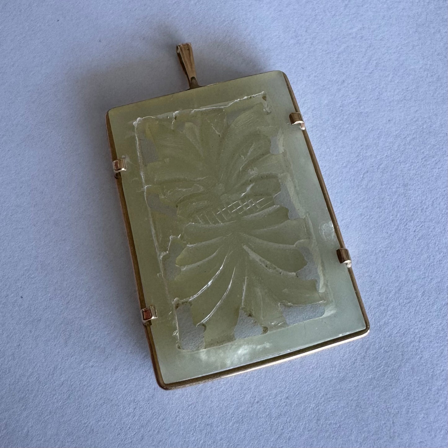 14K gold rectangular pendant set with a hand-carved milky Jade stone