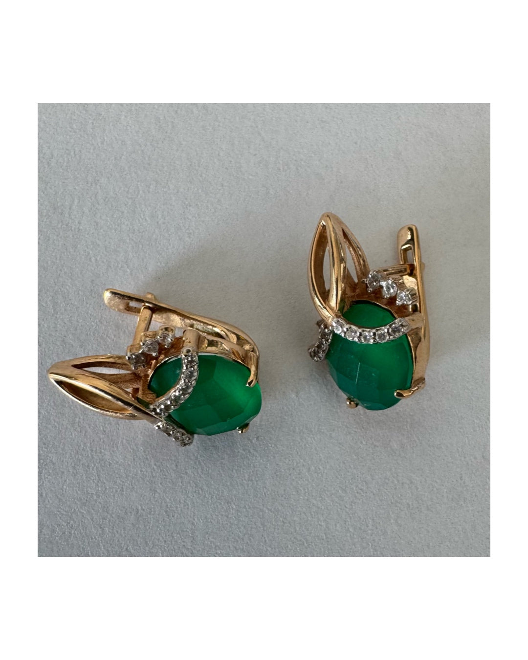 14K gold earrings set with vibrant green stones