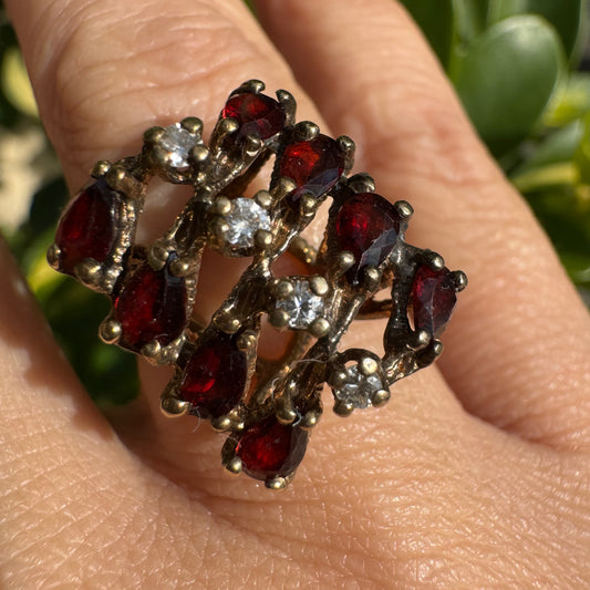 14K gold ring set with deep red teardrop Garnets and sparkling Diamonds in an openwork geometric design