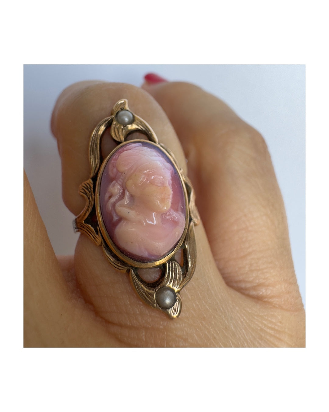 14K gold ring set with a hand-carved pink Cameo, framed by delicate details and accented with small Pearls.