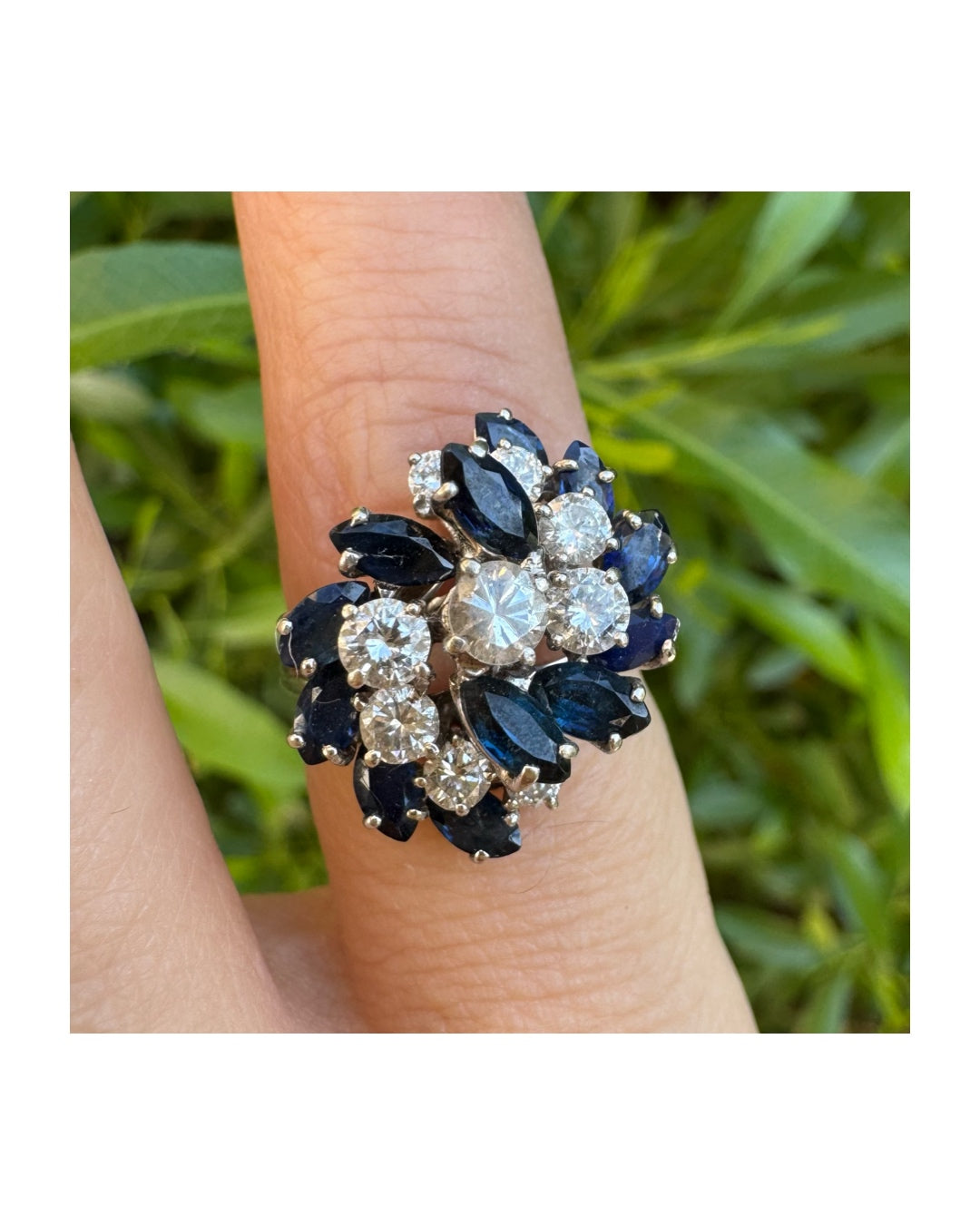 18K white gold ring, set with marquise-cut blue Sapphires and round Diamonds, in a classic cluster design.