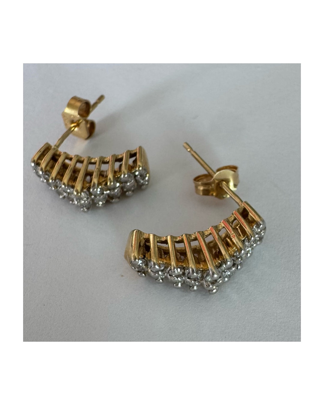 14K gold half-hoop earrings set with sparkling Diamonds in a dense pavé setting